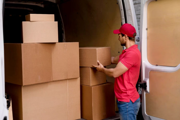 Moving Truck Loaded with Boxes in Suburban Home Driveway